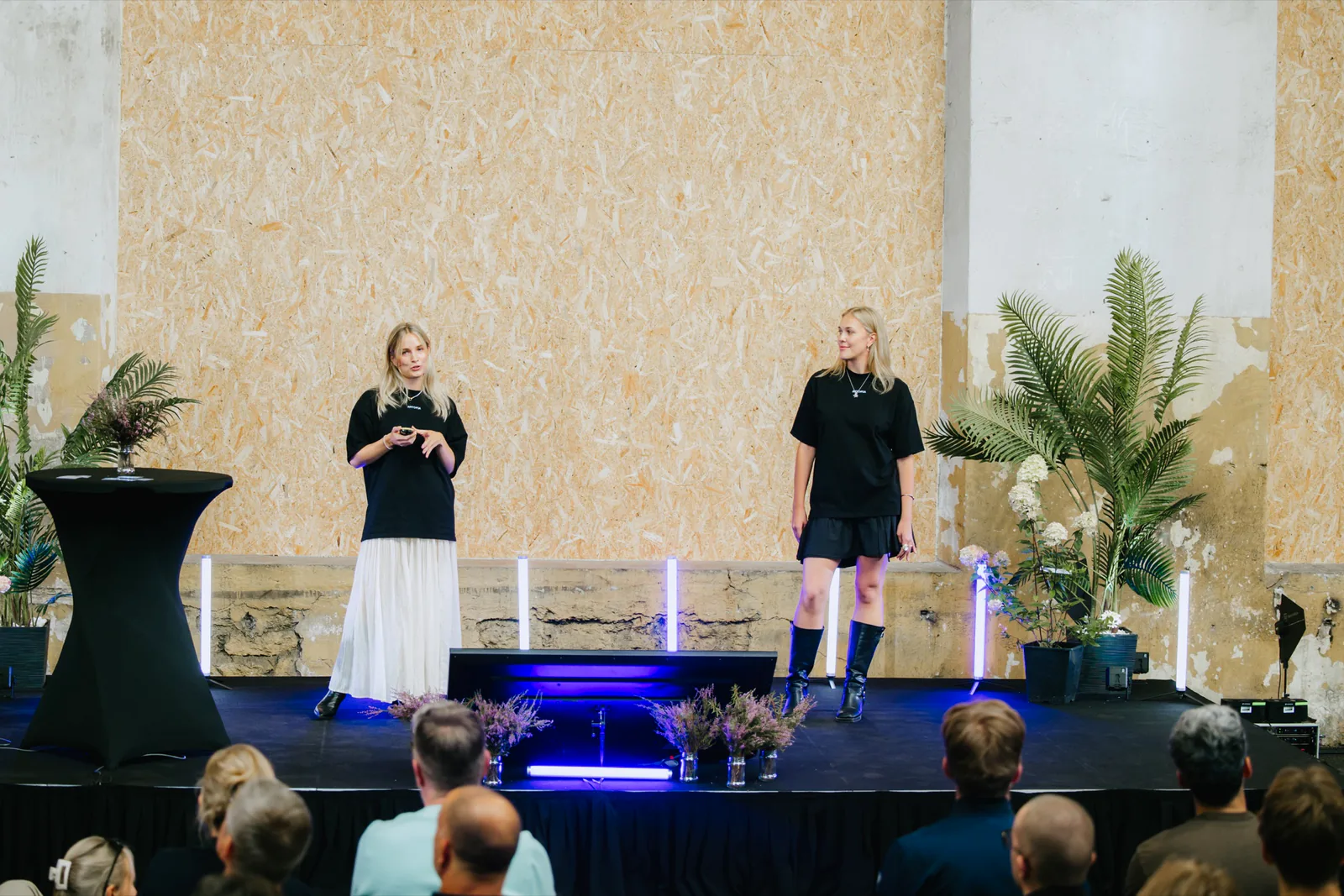 Iida Kaisa Urm and Elisabeth Lootus presenting Artopia onstage to an audience.